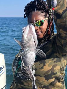 Fisherman with large 18-inch catch at Midway location