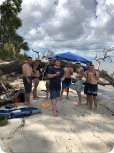 A group of 8 people fishing on the beach in Midway