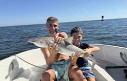 Two people fishing on the beach in Daytona Beach