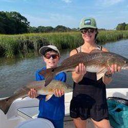 Two anglers enjoying a fishing trip in Charleston