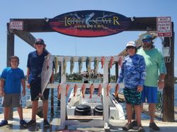 A group of 4 people fishing on the coast of Florida