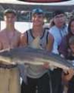 Three people enjoying a fishing trip in Panama City Beach