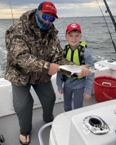 1 fishing rod in the hand with Panama City Beach in the background