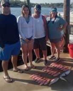 4 people fishing on the beach in Panama City Beach