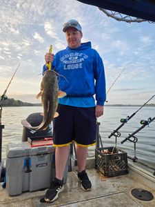 Proud angler proudly holding a 19-inch blue catfish in Mocksville