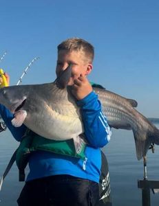 A single fisherman catching a 14-inch fish in North Carolina
