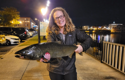 Angler catching a fish in Oswego