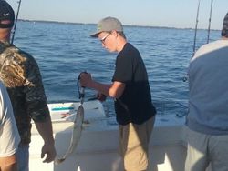 A person fishing on the lakeside in Marblehead