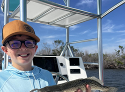 Angler holding a 13-inch fish at Fort Myers Beach