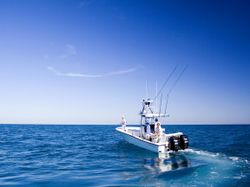 A lone fisherman casting a line into the ocean in Rincón
