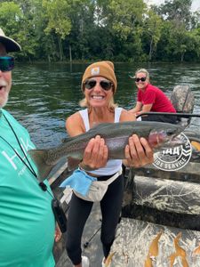 Image of two people fishing for a rainbow trout in Missouri