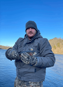 Angler posing with a small fish caught in Branson