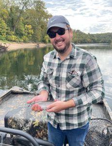 Fisherman with a rainbow trout catch in Branson