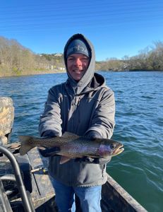 Angler with a rainbow trout catch in Branson