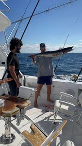 Two people fishing on a boat in Boynton Beach