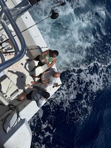 Two people enjoying a fishing cruise in Boynton Beach