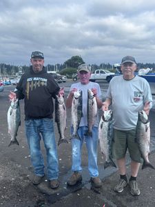 Successful salmon fishing trip in Charleston OR showing Chinook and Coho salmon catch