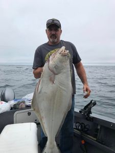 Large Pacific Halibut caught fishing in Charleston OR waters displayed on boat deck