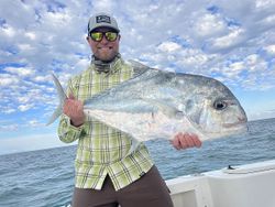 Angler holding a large African Pompano fish in FL