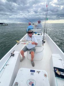 A photograph of a snook fish caught by two people fishing at New Smyrna Beach