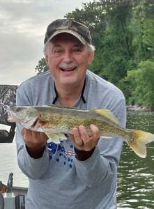 Fresh walleye catch held proudly on fishing boat in Forest Inn PA