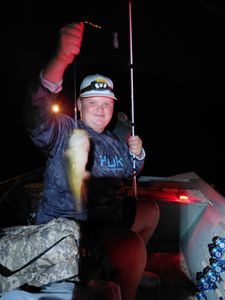 Night fishing scene with caught fish and fishing rod at Forest Inn PA