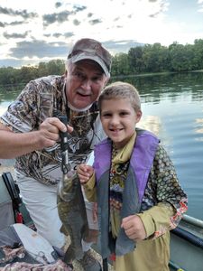 Smallmouth bass caught fishing at Forest Inn PA on calm lake with wooded shoreline