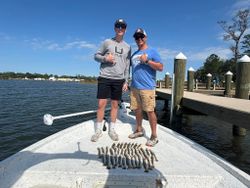 Fresh catch of fish displayed on boat deck at Gulf Shores AL marina with wooden dock pilings