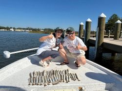 Successful fishing trip in Gulf Shores AL showing large catch of fish displayed on boat deck
