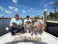 Successful Gulf Shores AL fishing trip with black drum, summer flounder, and hardhead sea catfish displayed on dock