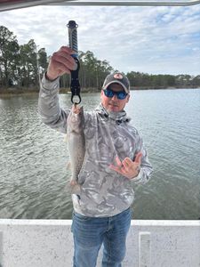 Speckled trout caught fishing in Gulf Shores AL held up with fishing pliers