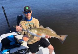 Angler posing with a single fish caught while fishing in Florida