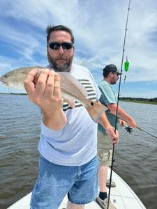 Angler posing with a large redfish caught in Florida