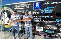 Two anglers reeling in redfish in Florida
