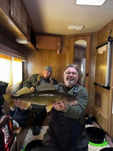 Anglers with a large walleye caught in Saskatchewan