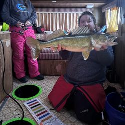 Angler holding a large walleye fish caught in Saskatchewan