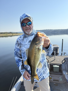 Nice largemouth bass caught with light tackle on calm water. Clear conditions made for an exciting day on the lake.