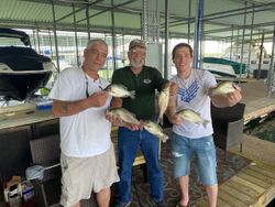 Two anglers hold their catch of two fish in TX