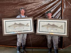 Two anglers fishing in Seadrift with two fish