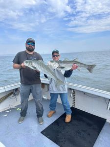 Two anglers fishing for striped bass in New Jersey