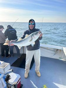 Two anglers fishing for striped bass in New Jersey
