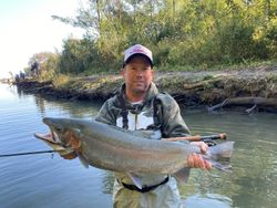Proud angler with a large rainbow trout caught while fishing in PA