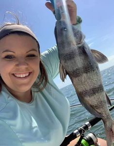 A photograph of a 14-inch black drum fish caught while fishing in FL.