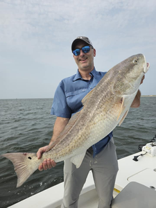 Angler holds large fish in Point Comfort