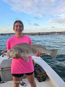 A lone fisherman casting his line in Point Comfort