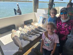 Fishing charter catch of black drum and redfish displayed on boat deck at Point Comfort TX