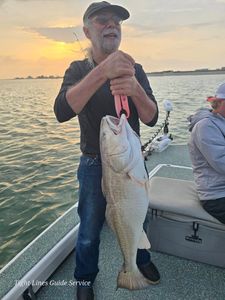 Large redfish caught on fishing boat at Point Comfort TX during sunset