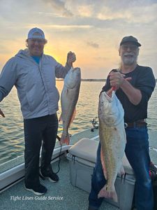 Two redfish caught on fishing boat at Point Comfort TX during sunset