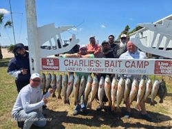 Successful redfish fishing trip at Point Comfort TX with large catch displayed at Charlie's Bait Camp