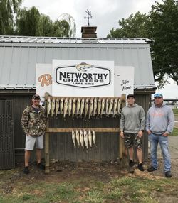 Three people enjoying a fishing trip at lakeside marblehead